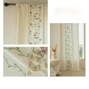 Detail showing pink spider lily embroidery and beige fringe on sheer curtains
