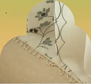 Detail of floral embroidery and handmade tassels on premium linen textured fabric