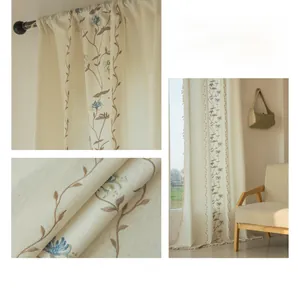 Close-up of fine floral embroidery on beige semi-blackout linen fabric curtains