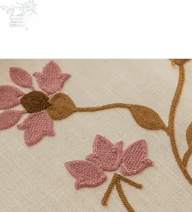 Macro detail of 3D floral embroidery on high-quality linen tablecloth fabric