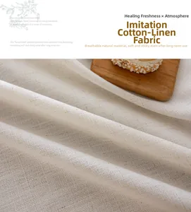 Close-up of cream floral embroidered tablecloth with fringe and woven linen texture