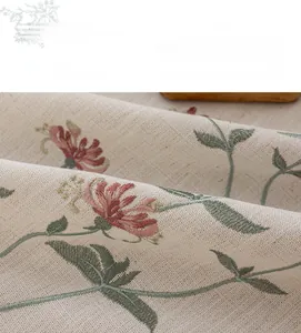 Detail of cream floral embroidery and fringe on minimalist cotton linen tablecloth