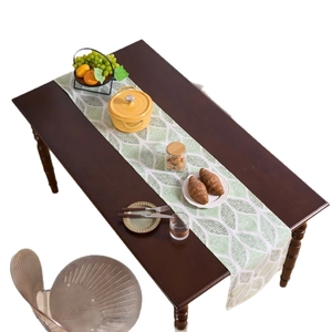 Nordic table runner with green geometric leaf pattern on white cotton linen blend fabric