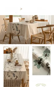 Detail of embroidered grey vine patterns and creamy tassels on cotton linen tablecloth