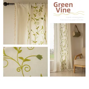 Close-up of green vine embroidery and beige tassel fringe on linen-style curtains