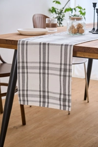 Close-up of modern gray and white plaid table runner with thick cotton linen texture
