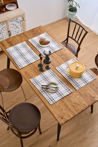 Close-up of grey and white checkered fabric placemats with heat-resistant texture