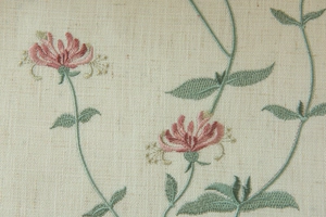 Macro detail of elegant pink flower embroidery on beige linen texture fabric curtain