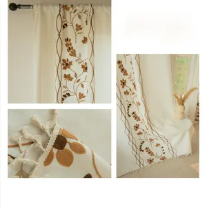 Close-up of vintage floral embroidery and tassel fringe on semi-sheer linen curtains