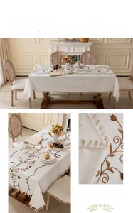 Close-up of vintage embroidered floral pattern and tassel fringe on linen tablecloth