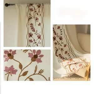 Detailed close-up of semi-sheer beige curtains with elegant purple floral embroidery
