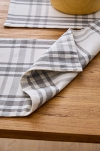 Close-up of grey and white checkered fabric placemat with thick woven linen texture