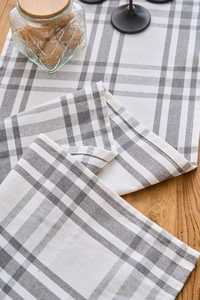 Detailed macro view of gray and white plaid table runner with a woven linen texture