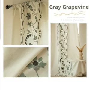 Detail of grey vine floral embroidery and tassel on semi-sheer beige linen curtains
