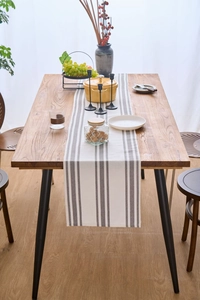 Detailed texture of grey and white striped table runner on a natural wooden dining table