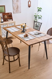 Nordic checkered fabric placemat on a wooden table with ceramic dinnerware and black decor