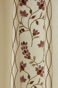 Detailed close-up of floral embroidery on rustic linen-textured semi-sheer curtains