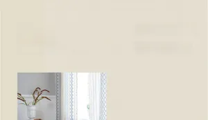 Detailed view of blue geometric pattern curtains featuring decorative beige tassel fringes