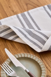 Detail view of Scandinavian grey and white striped table mat with cotton linen texture