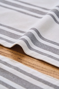 Close-up of Nordic grey striped fabric placemat texture with premium cotton linen stitching