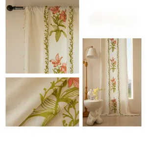Detailed embroidery of pink lilies and green vines on beige cotton linen curtains with tassels