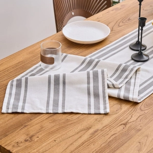 Nordic minimalist cream table runner with grey stripes on a dark wood dining table