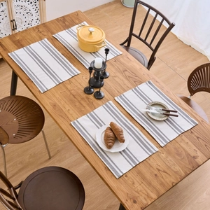 Set of 4 Nordic grey and white striped fabric placemats on a rustic wooden dining table