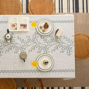 Rectangle beige linen tablecloth with green vine prints for a modern dining room setup