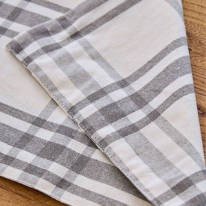 Nordic grey and white checkered fabric placemat made of linen on wooden table