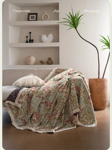 Detail of floral jacquard sofa throw blanket featuring vintage pink flowers and fringes