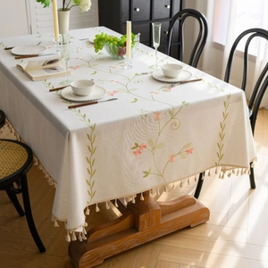 Elegant cream tablecloth with floral embroidery and tassel fringe for home dining decor