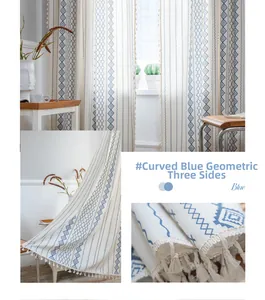 Close-up of blue geometric pattern curtains with beige fringe tassels in sunlight