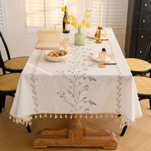 Rectangular cream tablecloth with blue floral embroidery and fringe tassels