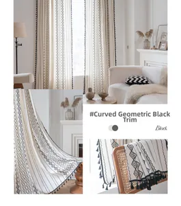 Detail of Nordic curtain with black geometric patterns and decorative fringe tassels