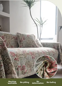Detailed macro view of pink floral jacquard sofa cover fabric with fringe edges