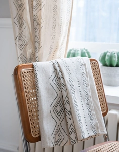 Close-up of geometric diamond pattern on natural cotton linen blend curtain fabric