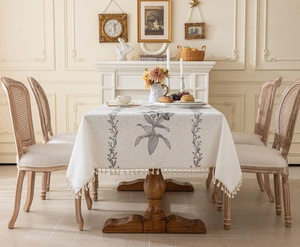 Détail de la nappe rectangulaire crème avec broderie florale et franges