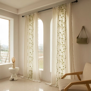 Beige cotton linen curtains with green botanical embroidery and decorative fringe edges