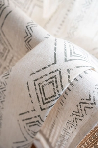 Macro shot of French retro cotton linen curtain with black geometric tribal patterns