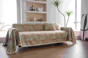 Close-up of pink floral jacquard sofa throw with fringe details and thick texture