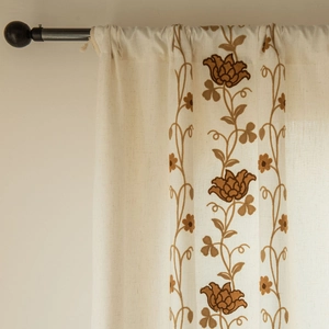 Detail of vintage floral embroidery on beige cotton linen fabric with rod pocket top
