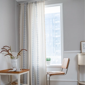 Modern cream window curtain with blue geometric diamond patterns and delicate side tassels
