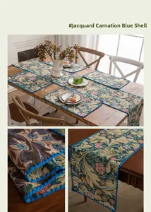 Detail of jacquard table runner with carnation embroidery and blue scalloped edges