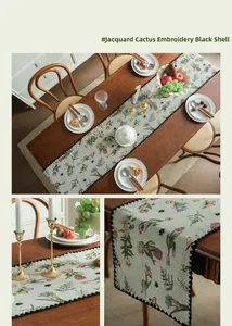 Detail of floral cactus embroidery on jacquard table runner with black scalloped edges