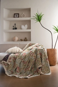 Close-up of thick woven floral jacquard texture with elegant white tassels on the edge
