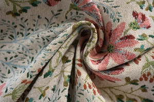 Macro shot of thick jacquard fabric featuring pink floral patterns and fringe details