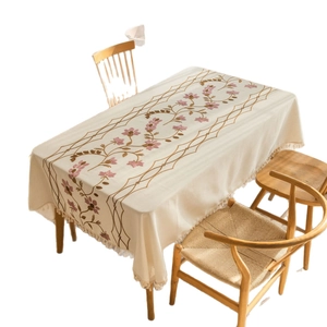 Elegant rectangular cream tablecloth featuring floral embroidery and tassel fringe edges
