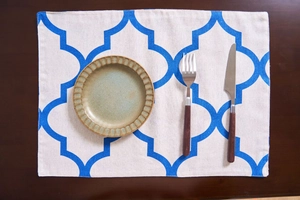 Close-up of cotton linen table runner featuring blue Moroccan clover geometric patterns