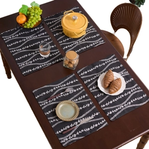 Set di 4 tovagliette moderne in bianco e nero con fiori su tavolo in legno