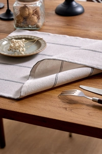 Detailed texture of Japanese style black and white striped linen fabric placemat on table